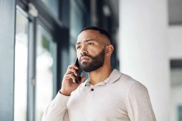 Thinking, serious and businessman talking on a phone call for networking, communication and idea. Listening, focus and employee with a mobile for conversation, discussion and connection at work